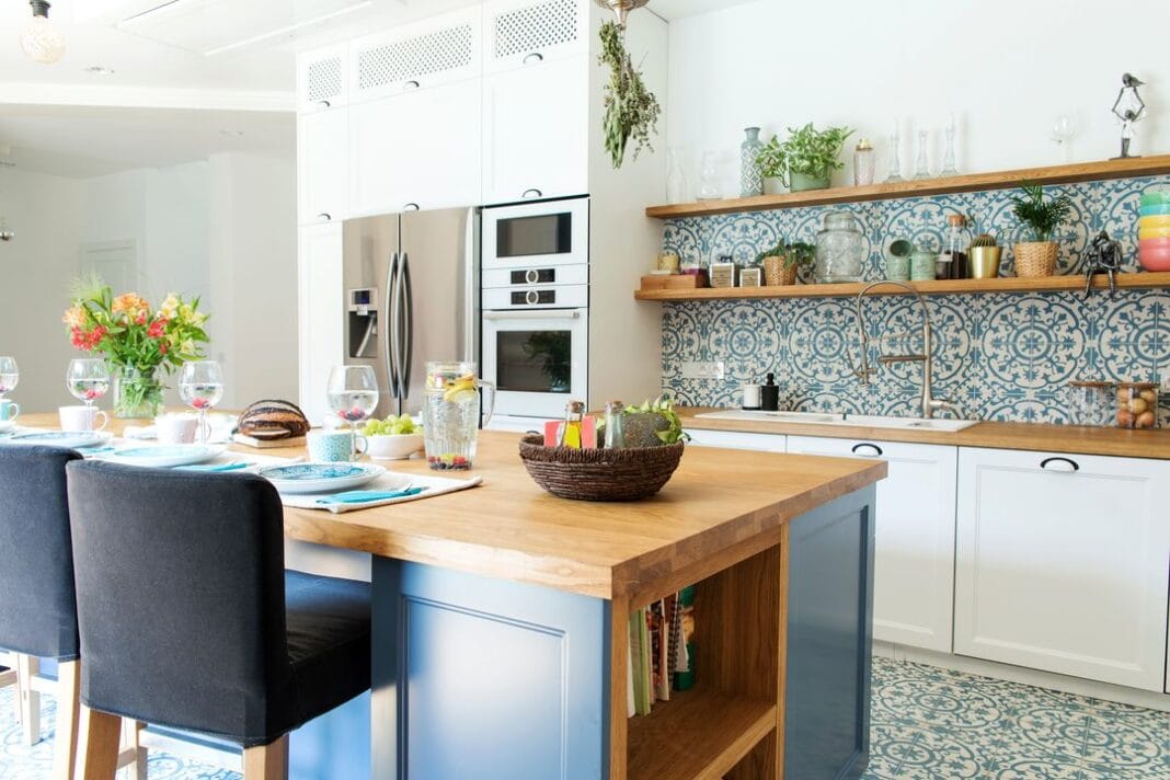 Stylish and sunny kitchen interior with accessories, wooden table and plants. Design space.